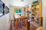 Gather around the charming wooden dining table, perfect for family game nights or intimate meals.