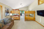 This spacious room features two sets of wooden bunk beds, perfect for accommodating multiple guests or children.