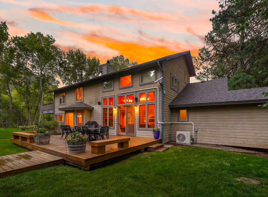 Experience luxurious outdoor living with this expansive multi-level deck, perfect for entertaining guests or enjoying a quiet evening.