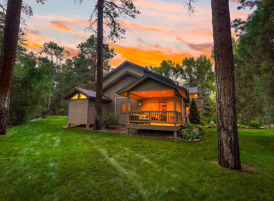 Nestled amidst a serene forest setting, this charming home offers a perfect retreat.