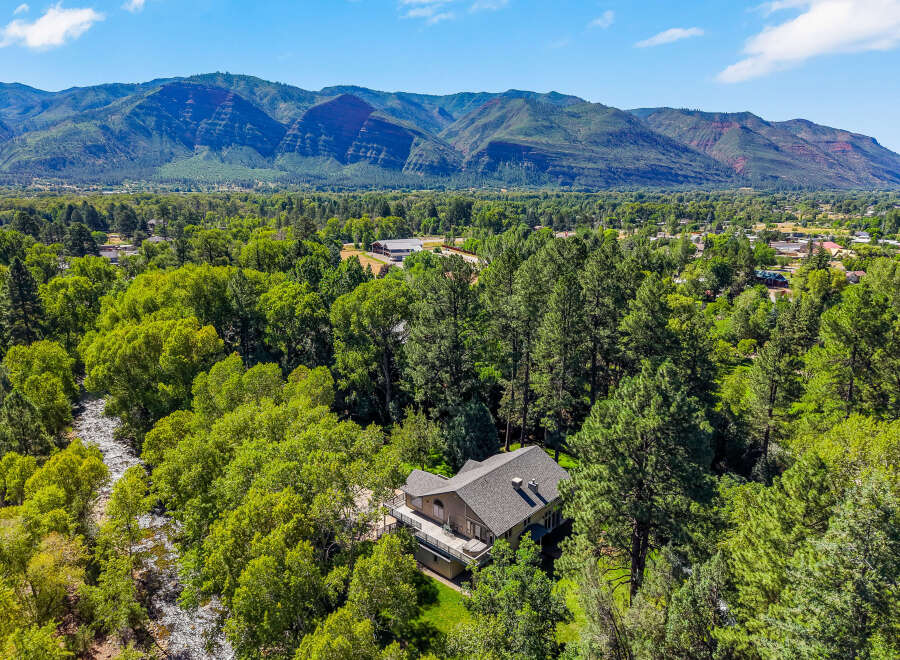 Nestled amidst lush greenery and bordering a serene river, this property offers a tranquil retreat with breathtaking mountain views.