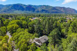 Nestled amidst lush greenery and bordering a serene river, this property offers a tranquil retreat with breathtaking mountain views.