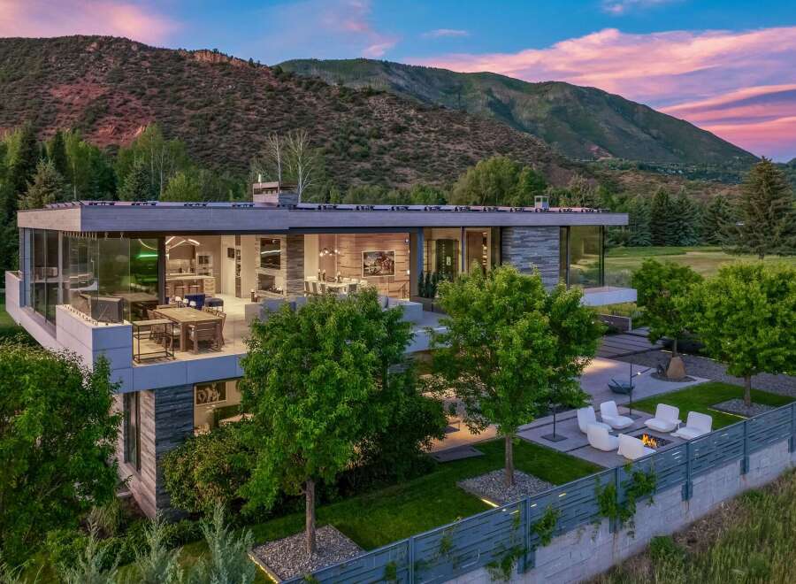 Experience luxury living in this modern architectural masterpiece, boasting expansive glass walls that seamlessly blend indoor and outdoor spaces.