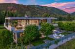 Experience luxury living in this modern architectural masterpiece, boasting expansive glass walls that seamlessly blend indoor and outdoor spaces.