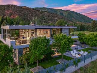 Experience luxury living in this modern architectural masterpiece, boasting expansive glass walls that seamlessly blend indoor and outdoor spaces.