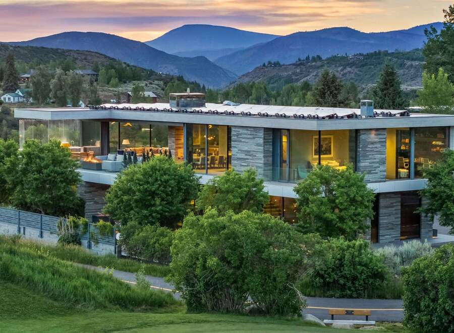 Experience modern luxury in this stunning mountain home, featuring expansive glass walls that blur the lines between indoor and outdoor living.