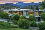 Experience modern luxury in this stunning mountain home, featuring expansive glass walls that blur the lines between indoor and outdoor living.