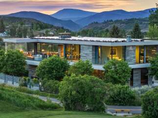 Experience modern luxury in this stunning mountain home, featuring expansive glass walls that blur the lines between indoor and outdoor living.