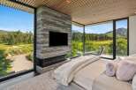 Experience luxury living with breathtaking golf course and mountain views from this stunning master suite.