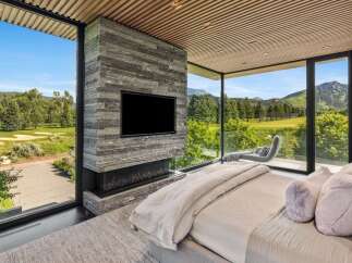 Experience luxury living with breathtaking golf course and mountain views from this stunning master suite.
