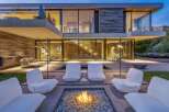 Experience luxury outdoor living with this stunning modern home featuring a sleek fire pit area perfect for evening gatherings.