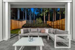 Experience outdoor living at its finest with this stunning patio featuring a spacious sectional sofa and a modern coffee table.