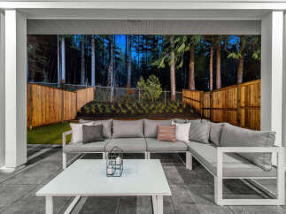 Experience outdoor living at its finest with this stunning patio featuring a spacious sectional sofa and a modern coffee table.