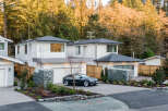 Discover modern living in this stunning new construction home, featuring a sleek Tesla parked in the driveway.