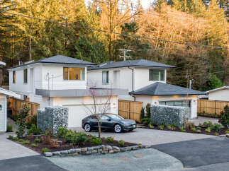 Discover modern living in this stunning new construction home, featuring a sleek Tesla parked in the driveway.