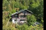 Nestled amidst a lush forest, this charming wooden chalet offers a serene mountain retreat.