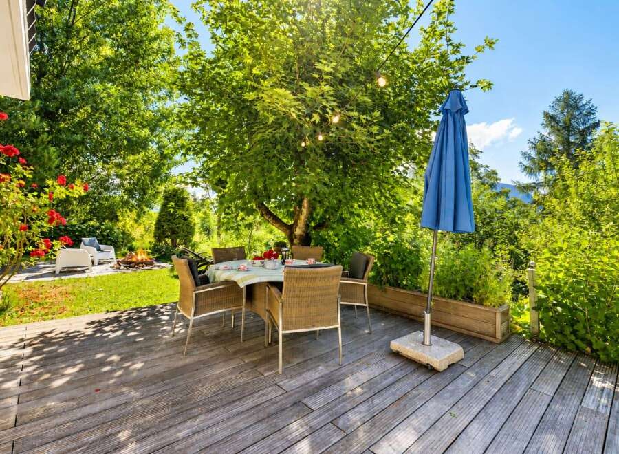 Enjoy al fresco dining on this charming wooden deck, perfect for entertaining guests or relaxing with family.