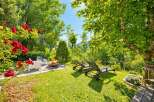Experience ultimate relaxation in this serene backyard oasis, featuring a cozy fire pit area perfect for evening gatherings.