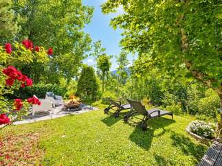 Experience ultimate relaxation in this serene backyard oasis, featuring a cozy fire pit area perfect for evening gatherings.