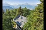 Experience sustainable living with this charming mountain home, featuring a modern roof equipped with solar panels for eco-friendly energy generation.