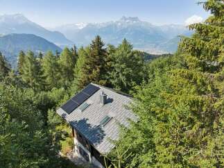 Experience sustainable living with this charming mountain home, featuring a modern roof equipped with solar panels for eco-friendly energy generation.