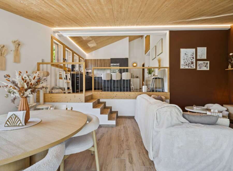 Experience modern living in this multi-level home featuring a sleek kitchen with bar seating and a cozy living area.