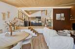 Experience modern living in this multi-level home featuring a sleek kitchen with bar seating and a cozy living area.