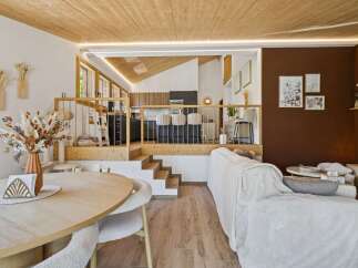 Experience modern living in this multi-level home featuring a sleek kitchen with bar seating and a cozy living area.