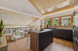 Experience modern living in this stunning attic kitchen, featuring a sleek island and ample counter space.