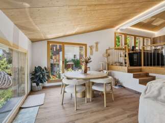 Experience modern mountain living in this stunning dining area, featuring a sleek round table with plush chairs perfect for intimate gatherings.