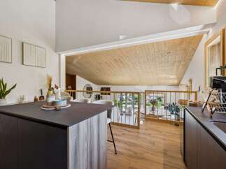 Experience modern living in this stunning open-concept kitchen and dining area, featuring a sleek island and ample natural light.