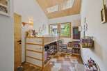 This charming children's room features a loft bed with ample storage underneath, perfect for toys and books.
