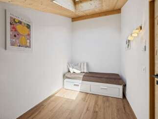 Discover this charming room featuring a comfortable daybed with convenient storage drawers, perfect for maximizing space.