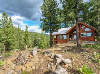Experience rustic charm and breathtaking mountain views from this stunning log cabin.
