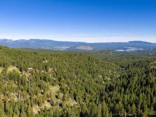 Discover your private mountain retreat nestled amidst a vast expanse of evergreen forest.