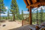 Experience breathtaking mountain views from the covered porch of this rustic log cabin.