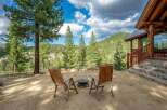Experience the ultimate mountain retreat with this stunning log cabin, offering breathtaking views of a lush, forested landscape.