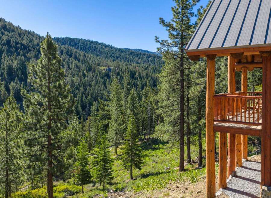 Experience the serene beauty of this mountain retreat, nestled amidst a lush forest of towering pine trees.