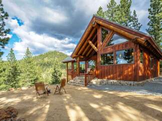 Experience rustic charm and modern comfort in this stunning log cabin nestled amidst a picturesque mountain landscape.