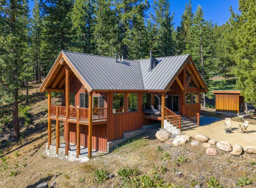 Nestled amidst towering pine trees, this charming log cabin offers a serene mountain retreat.