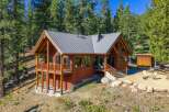 Nestled amidst towering pine trees, this charming log cabin offers a serene mountain retreat.