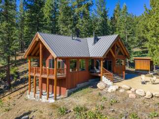 Nestled amidst towering pine trees, this charming log cabin offers a serene mountain retreat.