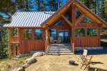 Experience rustic charm and modern comfort in this stunning log cabin nestled amidst a serene forest landscape.