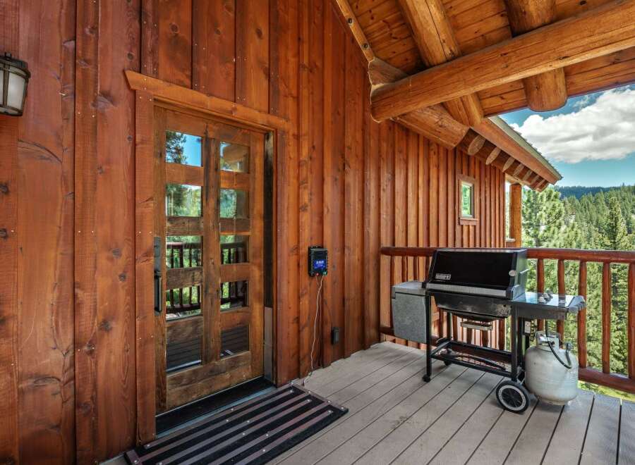 Experience the ultimate mountain retreat with this charming log cabin featuring a spacious wooden deck perfect for outdoor entertaining.