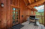 Experience the ultimate mountain retreat with this charming log cabin featuring a spacious wooden deck perfect for outdoor entertaining.