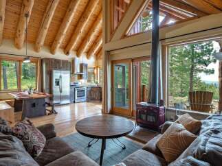 Experience rustic charm and modern comfort in this stunning log cabin living space.
