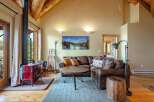 Experience rustic charm in this cozy living room, featuring a striking red wood-burning stove and exposed wooden beams that add warmth and character.