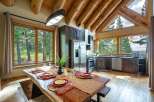 Experience rustic charm and modern comfort in this stunning log cabin kitchen and dining area.