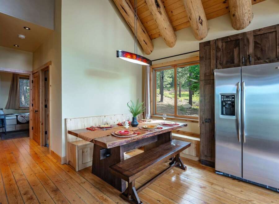 Experience rustic charm in this dining area featuring a live-edge wood table and benches, perfect for intimate gatherings.