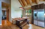 Experience rustic charm in this dining area featuring a live-edge wood table and benches, perfect for intimate gatherings.